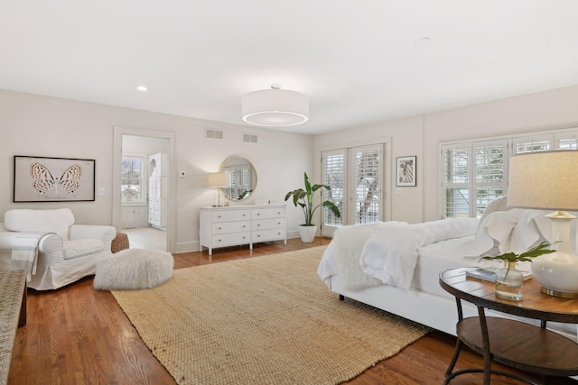 bedroom featuring access to exterior and hardwood / wood-style flooring