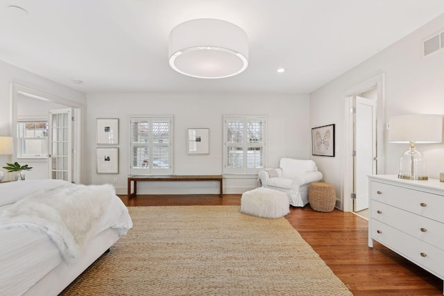 bedroom with dark hardwood / wood-style floors