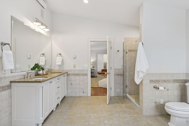 bathroom featuring tile walls, vanity, tile patterned floors, and an enclosed shower