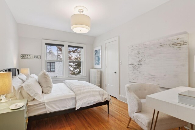 bedroom featuring wood-type flooring and radiator