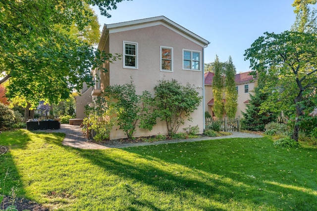 view of property exterior with a lawn