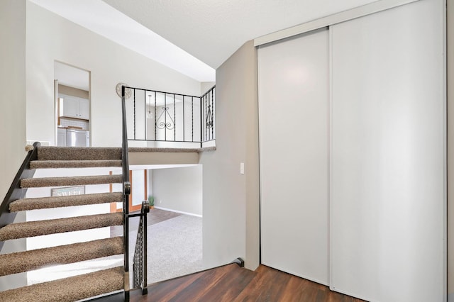 stairway with hardwood / wood-style floors