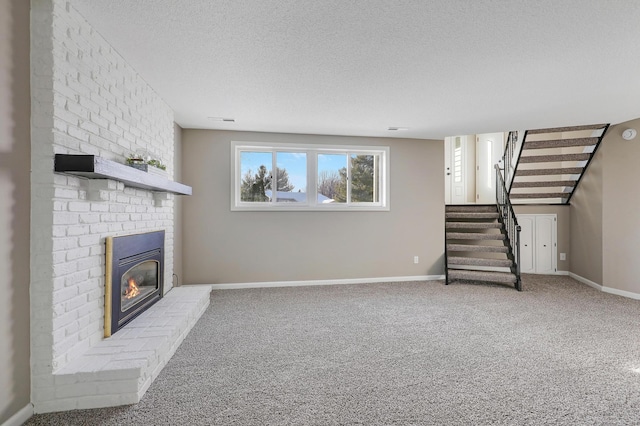 unfurnished living room with carpet, a textured ceiling, and a fireplace