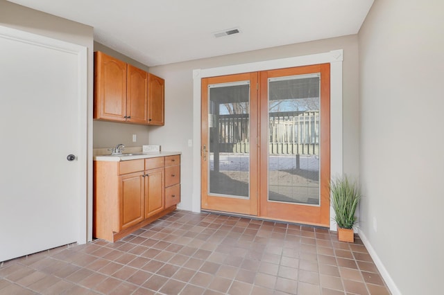 kitchen featuring sink, tile patterned floors, and french doors