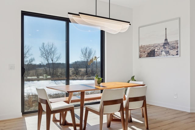 dining space with light wood-type flooring