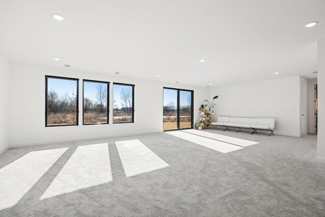 unfurnished living room featuring light colored carpet