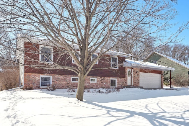 exterior space with a garage and brick siding