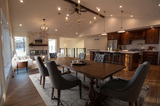 dining space featuring a fireplace, sink, dark hardwood / wood-style flooring, a notable chandelier, and wooden ceiling