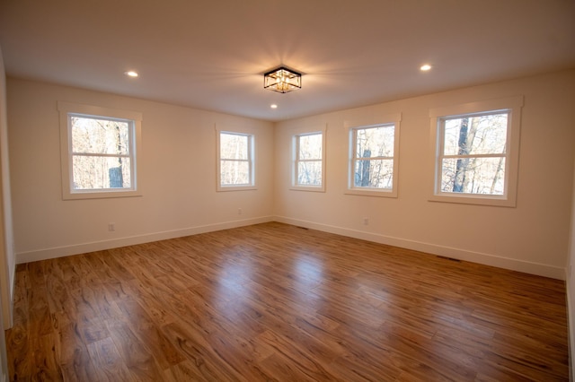 unfurnished room featuring hardwood / wood-style floors