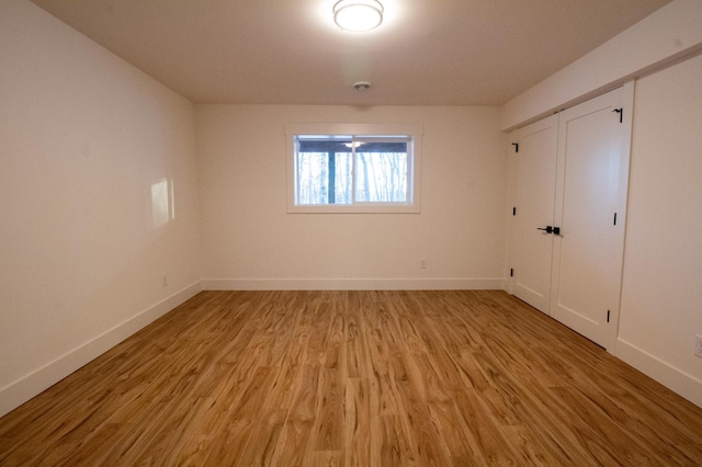 unfurnished bedroom featuring a closet and light wood-type flooring