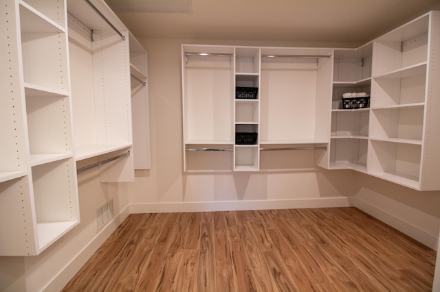 spacious closet with light hardwood / wood-style flooring