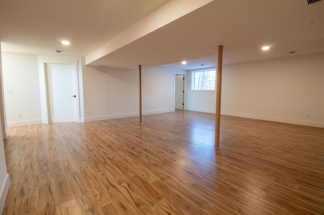 basement with hardwood / wood-style floors