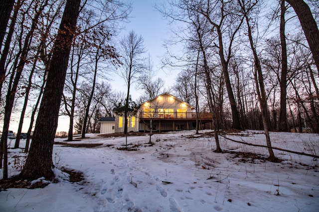 snowy yard featuring a wooden deck