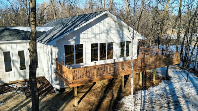 view of snow covered exterior featuring a wooden deck