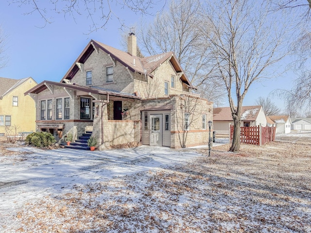 view of snow covered back of property