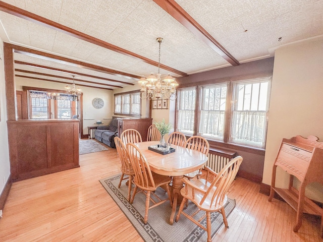 dining room with plenty of natural light, a chandelier, and light wood-type flooring