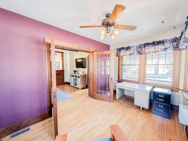 office with ceiling fan and light hardwood / wood-style flooring