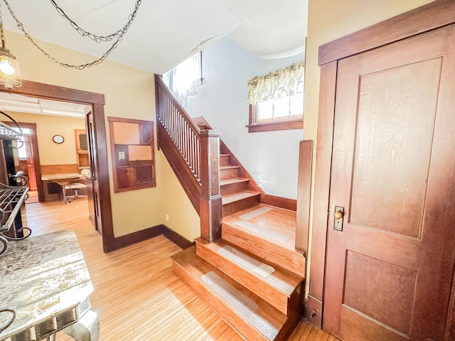 staircase with hardwood / wood-style floors