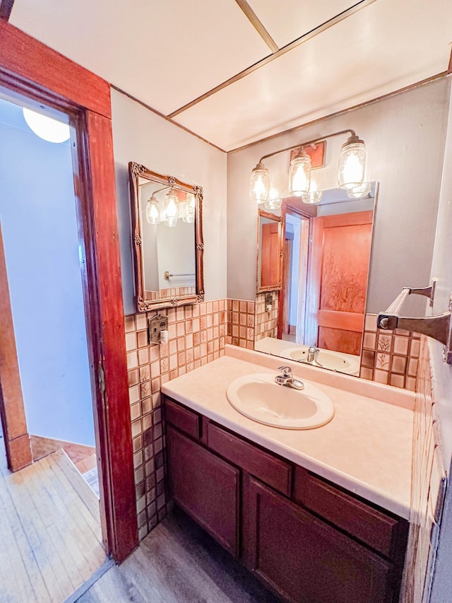 bathroom featuring vanity and tile walls