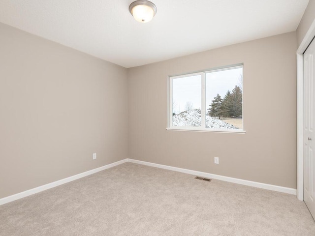 spare room with light colored carpet