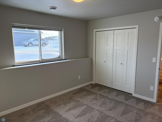 unfurnished bedroom featuring a closet and carpet flooring