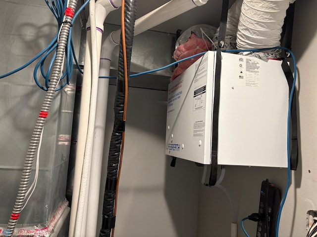 utility room with tankless water heater