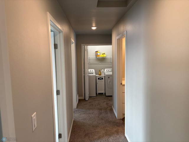 hallway with washer and clothes dryer and carpet