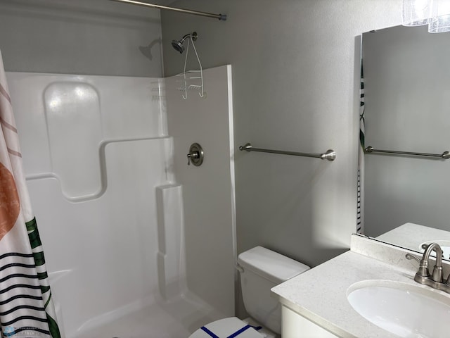 bathroom with vanity, toilet, and curtained shower