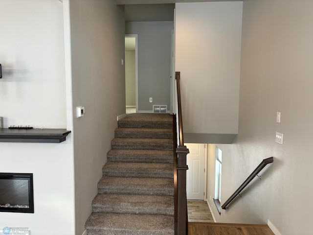 staircase with hardwood / wood-style flooring