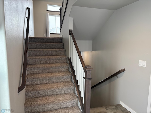 stairway with lofted ceiling