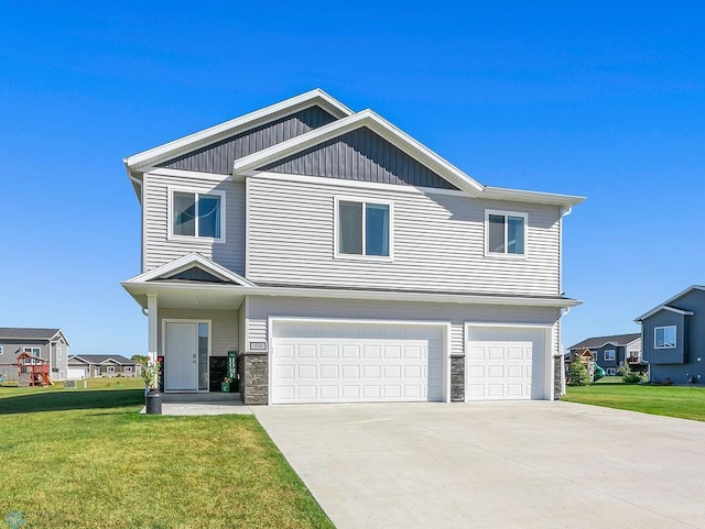 view of front of home with a garage and a front lawn