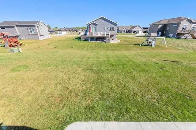 view of yard with a playground and a deck