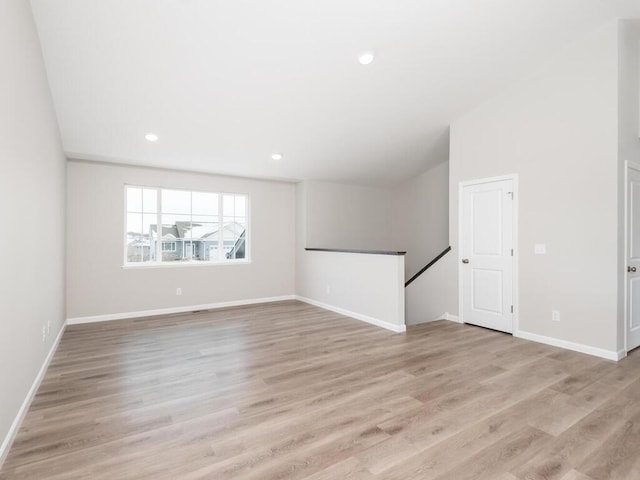 empty room with light hardwood / wood-style flooring