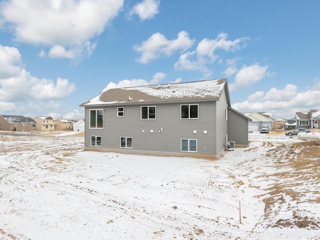 snow covered rear of property with cooling unit