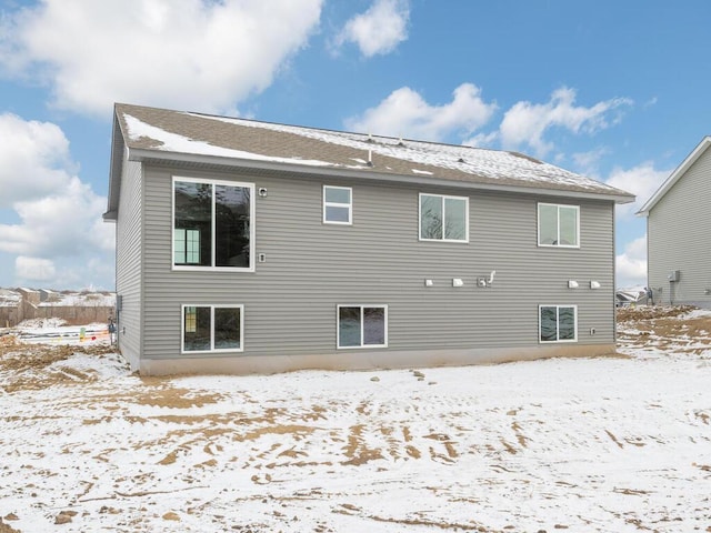 view of snow covered rear of property