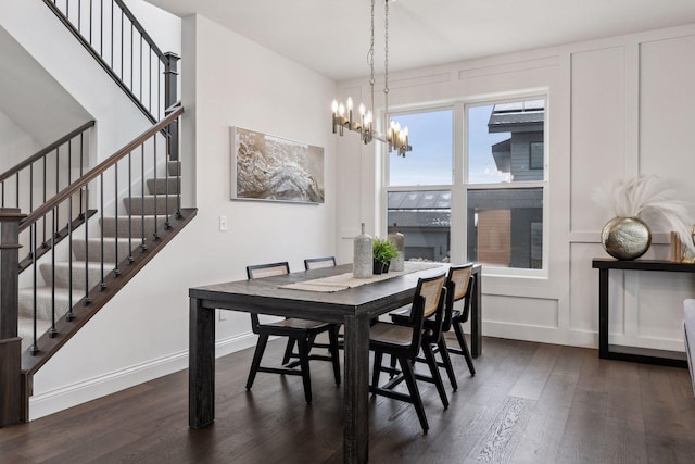 dining space featuring dark hardwood / wood-style floors and a chandelier