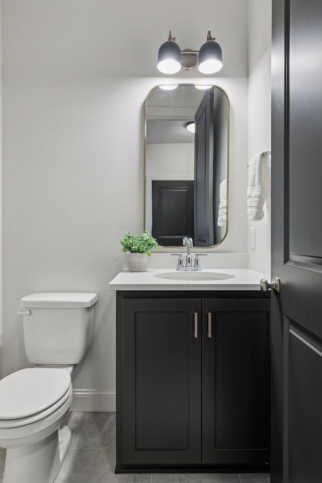 bathroom featuring tile patterned floors, vanity, and toilet