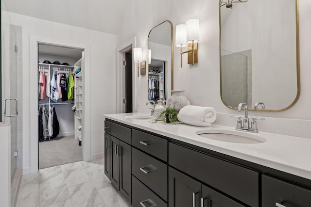 bathroom featuring walk in shower and vanity