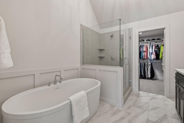 bathroom featuring vanity and separate shower and tub