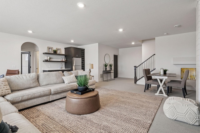 carpeted living room featuring a textured ceiling