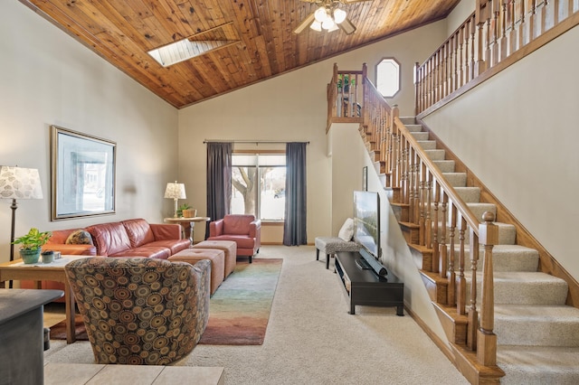 living area with high vaulted ceiling, wooden ceiling, a skylight, stairs, and carpet