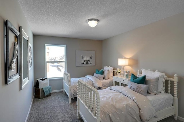 bedroom featuring carpet, a textured ceiling, and baseboards