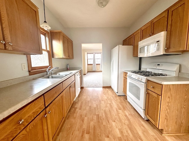 kitchen with plenty of natural light, sink, white appliances, and decorative light fixtures