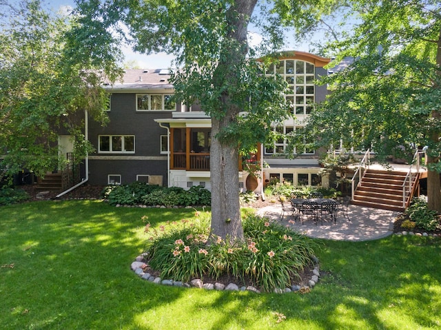 back of property featuring a yard and a patio area