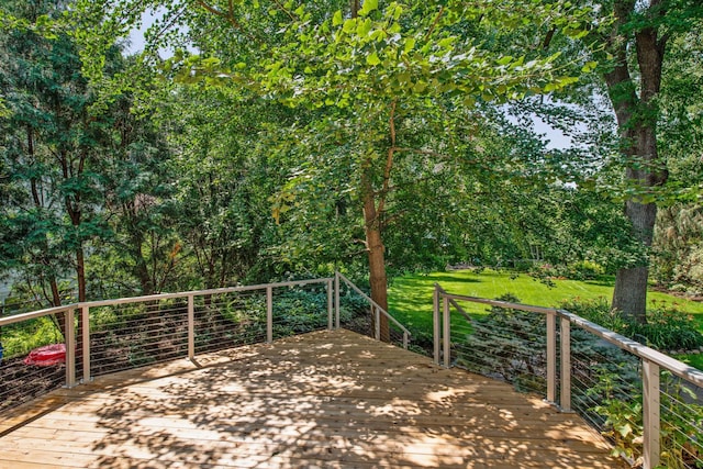 wooden terrace featuring a yard