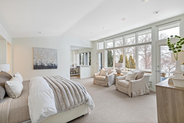 bedroom featuring light colored carpet and vaulted ceiling