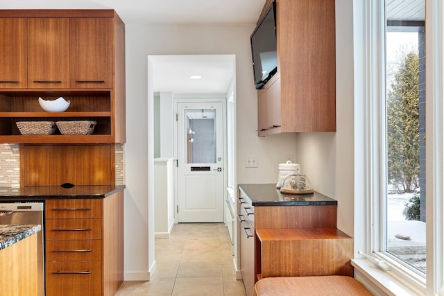 kitchen featuring a healthy amount of sunlight, stainless steel dishwasher, and light tile patterned floors