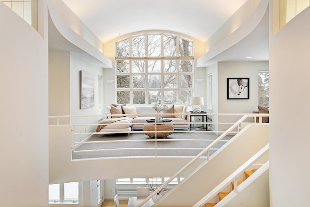 living room featuring lofted ceiling and a wealth of natural light