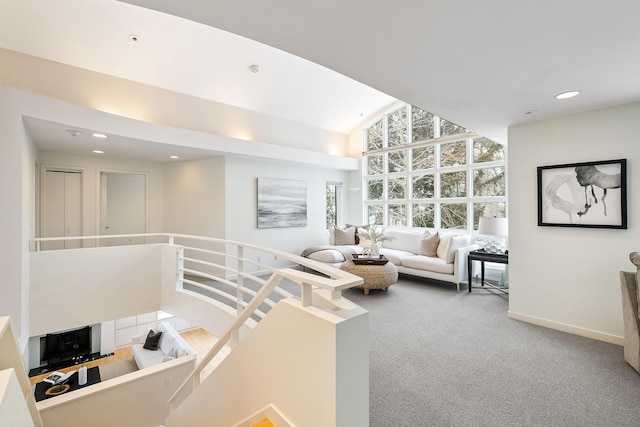 carpeted living room featuring high vaulted ceiling