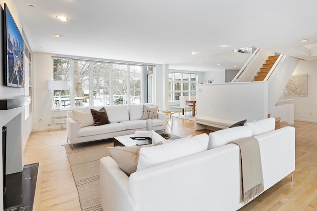 living room featuring plenty of natural light and light hardwood / wood-style flooring